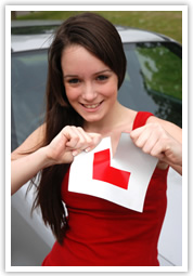 Female learner driving ripping up L plates after passing driving test the first time